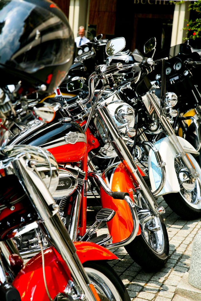 Close-up of vintage motorcycles at an outdoor exhibition, showcasing classic design.